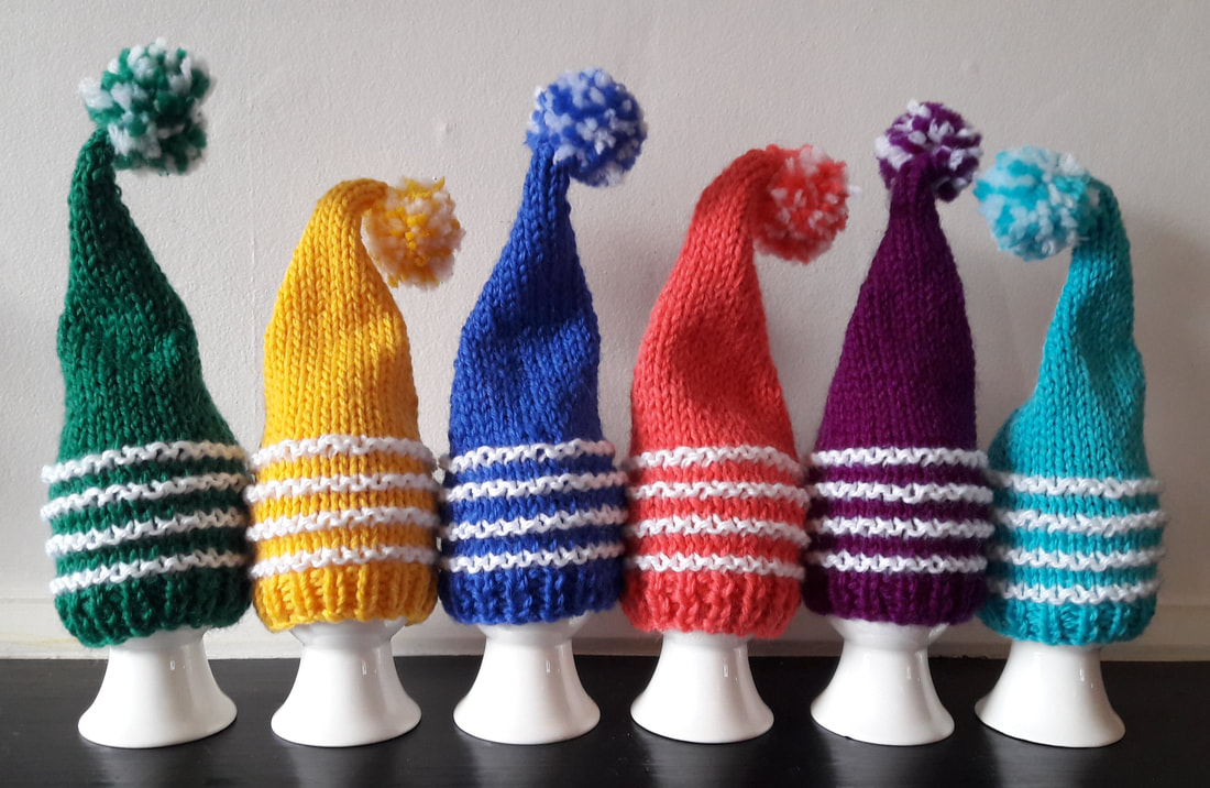 6 brightly coloured single point knitted egg cosies